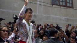 Burmese pro-democracy leader Aung San Suu Kyi waves to Burmese migrant workers on a trip to a Burmese migrant community outside of Bangkok May 30, 2012 in Mahachai, Samut Sakhon, Thailand. 