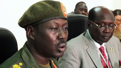 File photo of South Sudan's army spokesman Philip Aguer, left, who is skeptical that troops have pulled out. 
