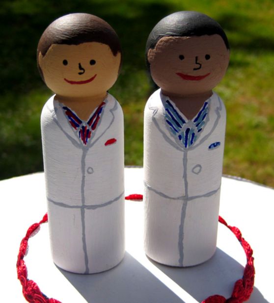 Alex and Tony wanted to keep their wedding simple and inexpensive: They made picnic lunches for guests and painted wooden dolls in their likeness for cake toppers.