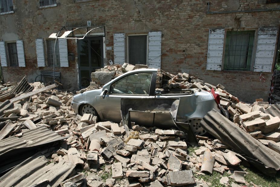 A car is crushed by falling rubble from a building in Carvezzo, Italy following the 5.8-magnitude earthquake on May 29, 2012.