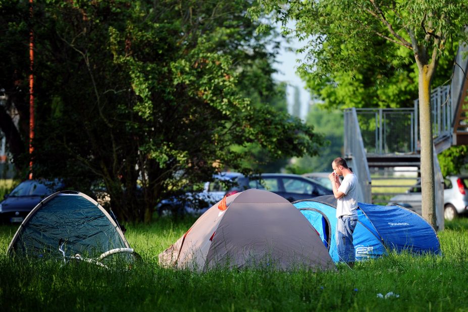 Local people wake up after sleeping in a park early on May 30, 2012 in Crevalcore. Dozens of aftershocks hit northeastern Italy overnight as thousands of jittery survivors spent the night in tents. 