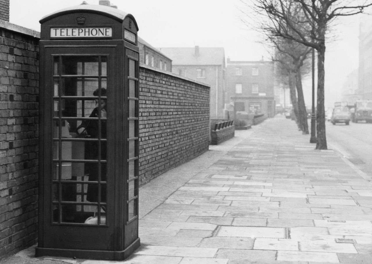 If you wanted to make a phone call in 1952, you most likely had to use a box in the street. This one was snapped in 1963 but the familiar red design remained for decades.