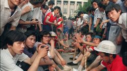 Beginning the night of June 3, 1989, and stretching into the early morning of June 4, Chinese troops used lethal force to end a seven-week-long occupation of Tiananmen Square by democracy protestors in Beijing.  In this photo, students and workers armed with wooden sticks gather outside the Great Hall of the People on June 3.