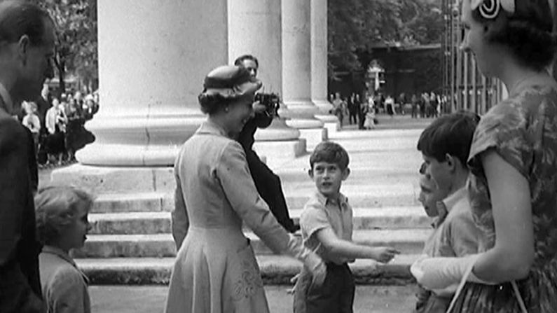 Prince Charles introducing his mother, The Queen, to his school teachers and fellow pupils at Sports Day, Hill House School, West London in the summer of 1957.