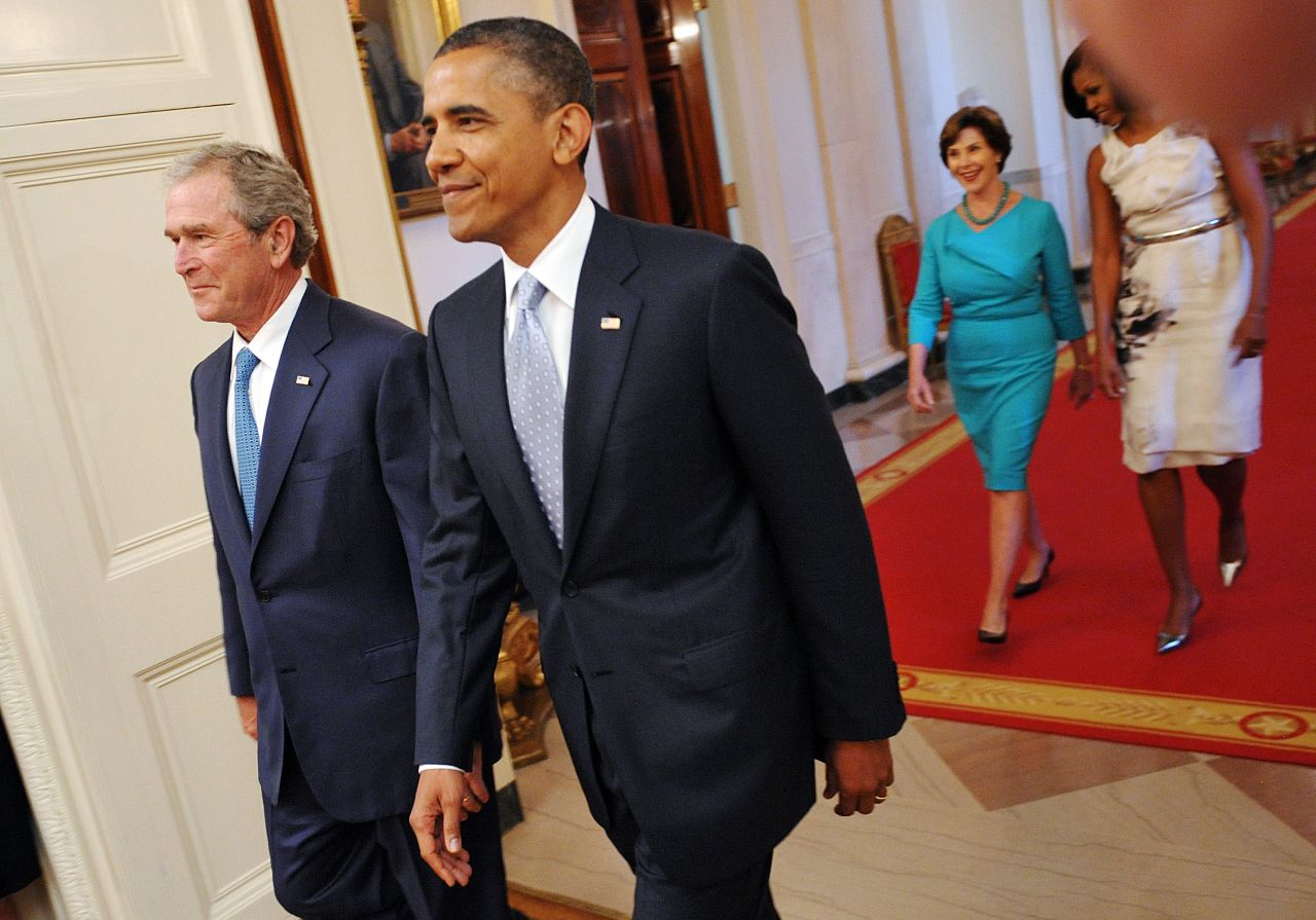 President Barack Obama, former President George W. Bush, first lady Michelle Obama and former first lady Laura Bush enter the East Room of the White House for Bush's portrait unveiling. 