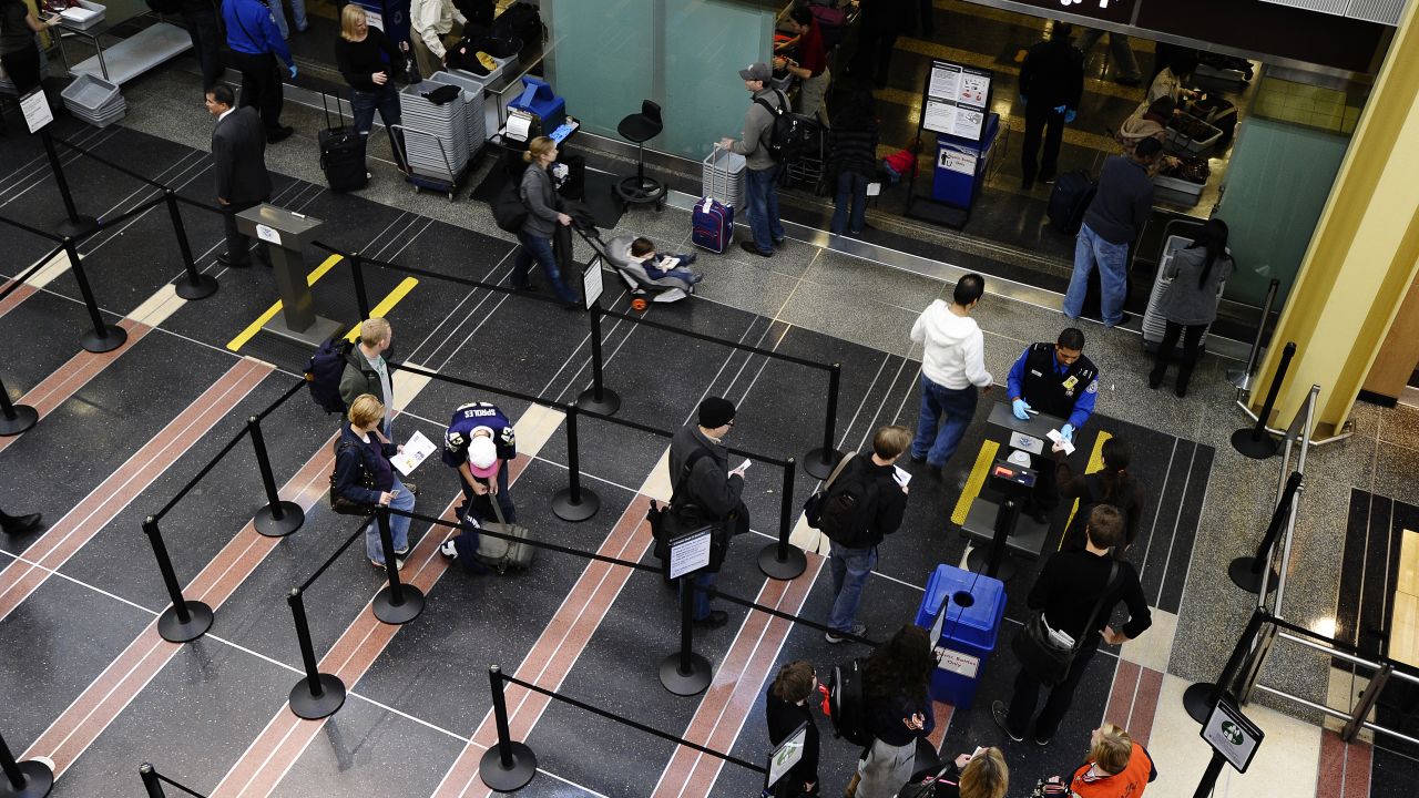 Travelers go through a TSA checkpoint at Reagan National Airport in Washington.