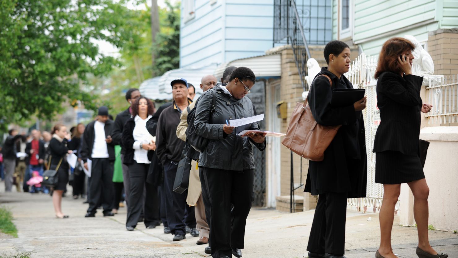 People seeking jobs wait in line at an employment fair in New York in May 2012.