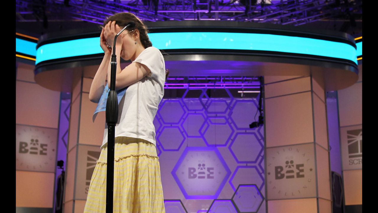 Speller Lena Greenberg of Philadelphia covers her face during round 9 of the competition after she misspelled the word "geistlich."  Greenberg was eliminated from the competition.  