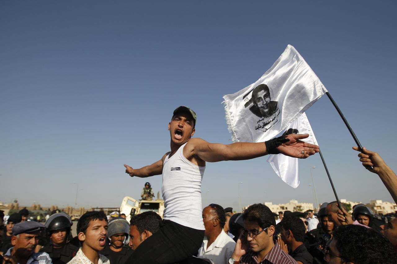 Youths protest Mubarak in Cairo.
