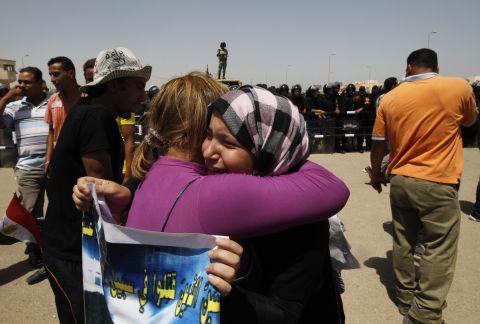 Emotional anti-Mubarak protesters embrace after the verdict against the former president was handed down.