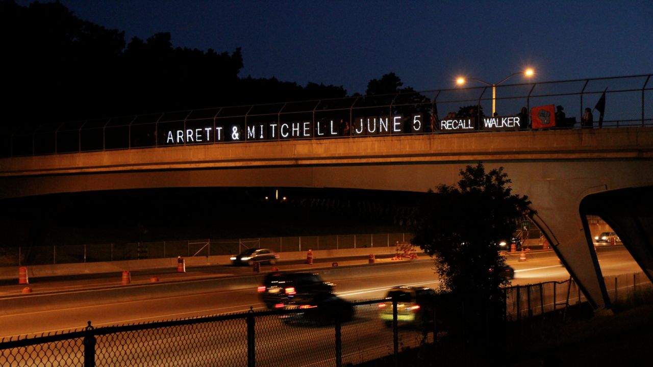 A sign on an overpass calls for the recall of Gov. Scott Walker.