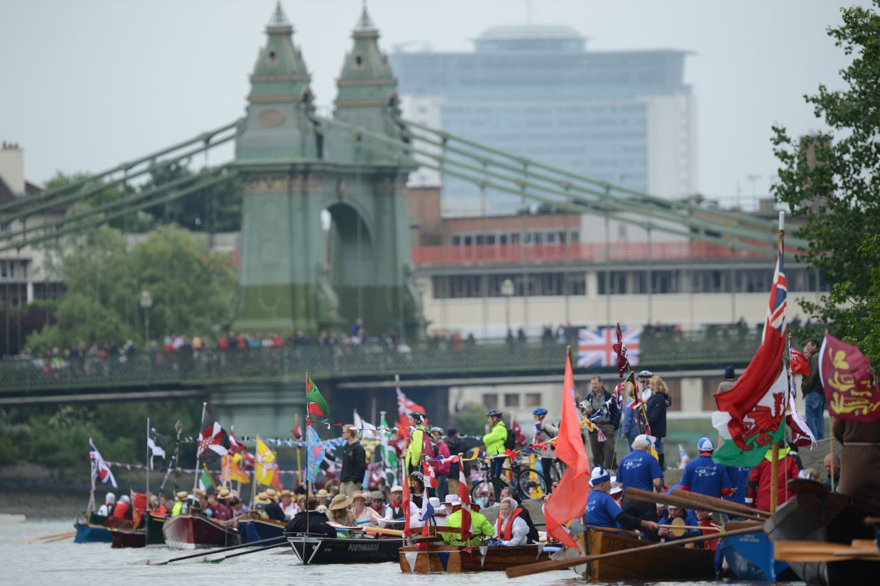 Participants sit in row boats in preparation for the start of the jubilee flotilla along the Thames for the queen's diamond jubilee.