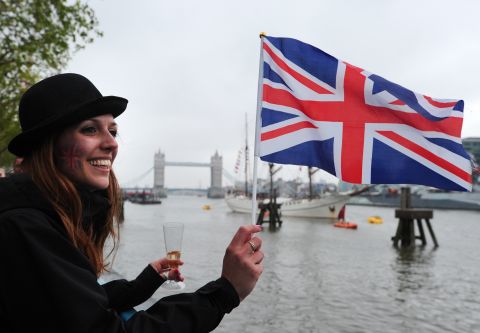 A woman flies a Union flag during the Thames Diamond Jubilee Pageant on the River Thames in London on June 3, 2012.
