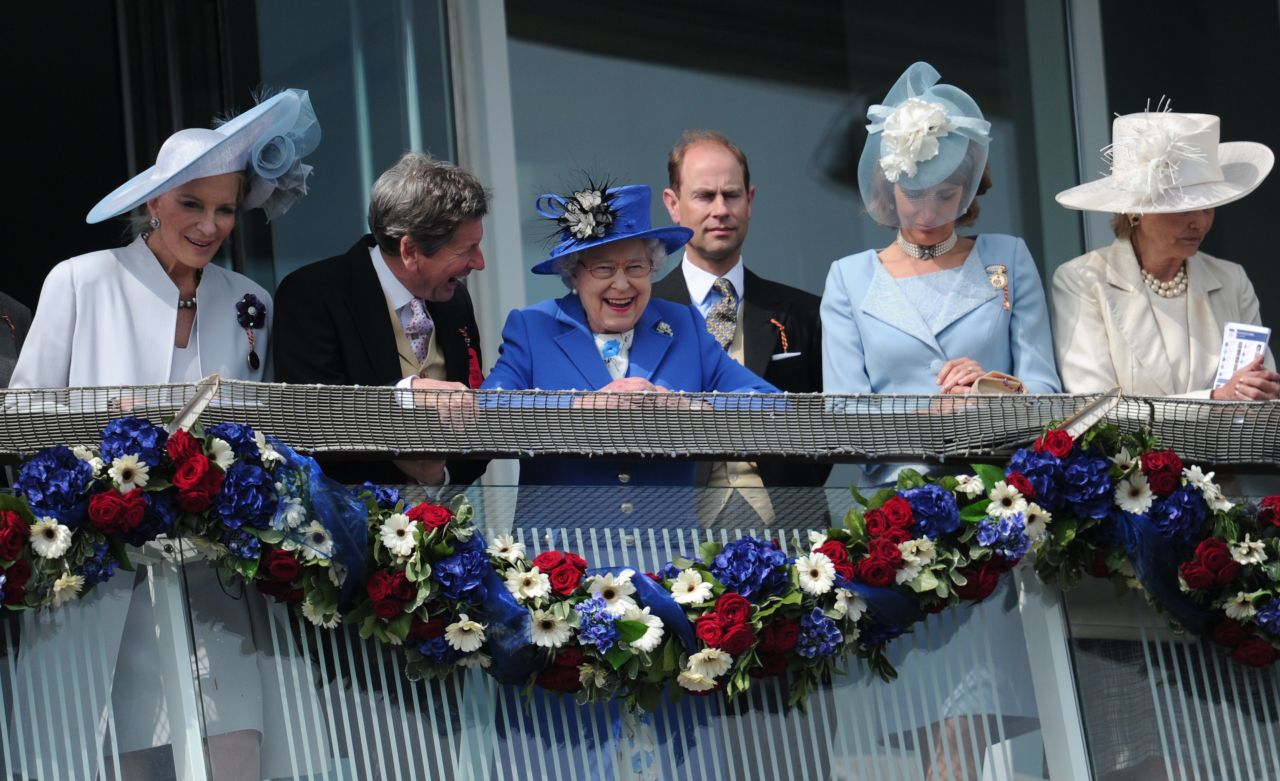 Britain's queen spends a day at the Epsom Derby marking the opening of her Diamond Jubilee weekend on June 2, 2012. Elizabeth II smiles from the royal balcony with Prince Edward, Earl of Wessex behind her.