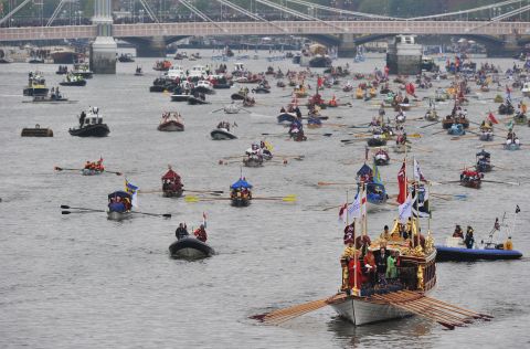 The queen's royal barge, Gloriana leads the way as the River Thames is awash with color from flotilla participants. 