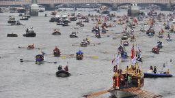 The queen's royal barge, Gloriana leads the way as the River Thames is awash with color from flotilla participants. 