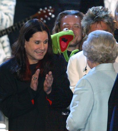 During 'Party at the Palace' in honor of the Queen's 2002 Golden Jubilee celebrations, the queen meets bat-eating Black Sabbath frontman Ozzy Osbourne and bizarrely, Kermit the Frog at the same time. 12,000 people watched a pop concert featuring singers spanning many generations in the garden of Buckingham Palace to celebrate Queen Elizabeth's 50 years on the throne.