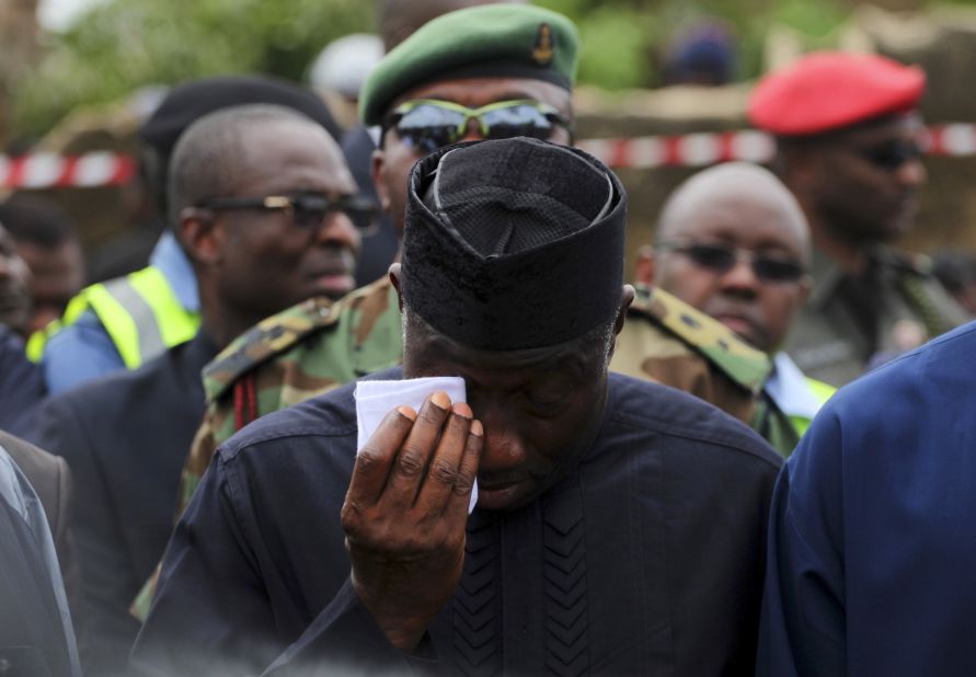 President Goodluck Jonathan wipes a tear during a visit to the site of the crash in Lagos on Monday.
