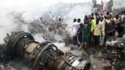 Image #: 18132174    People gather near the engine of a plane, after it crashed into a neighbourhood in Ishaga disrict, an outskirt of Nigeria's commercial capital Lagos June 3, 2012. There were no survivors among the 147 people on board a domestic passenger aircraft that crashed in the Nigerian city of Lagos on Sunday, an official of the National Emergency Management Agency (NEMA), told Reuters.           REUTERS/Akintunde Akinleye  (NIGERIA - Tags: DISASTER TRANSPORT TPX IMAGES OF THE DAY)       REUTERS /AKINTUNDE AKINLEYE /LANDOV