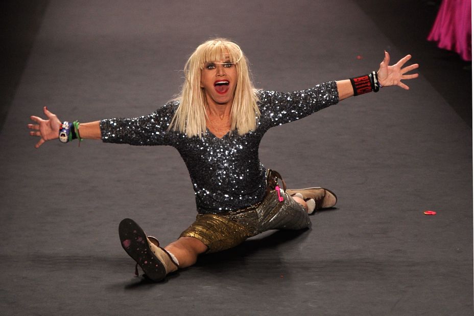 Betsey Johnson does a split on the runway at the Betsey Johnson Fall 2012 fashion show. She is also known for doing a cartwheel at the end of each fashion show.