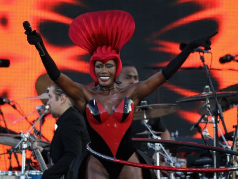 Singer Grace Jones sings her hit "Slave to the Rhythm" while spinning a hula hoop on her hips.