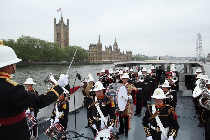 Members of Queen Elizabeth II 's Royal Marine Band, Plymouth, play in the pouring rain during the pageant, they were joined by a number of choirs and orchestras playing music along the route.