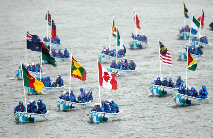 A flotilla of 55 Trinity 500's boats crewed by sea cadets from across Britain, carring the 54 Commonwealth flags, travel down the river in the pouring rain. 