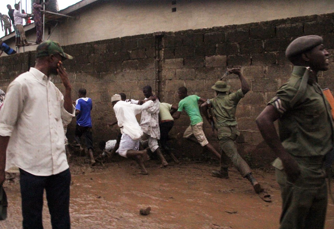 Soldiers disperse onlookers near the site of the crash.