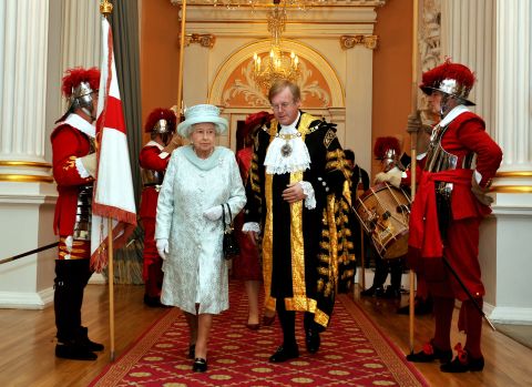 Britain's Queen Elizabeth II walks with David Wooton, the Lord Mayor of London, after arriving at Mansion House in London, in honour of her Diamond Jubilee, on June 5, 2012. 