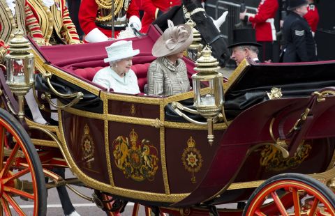 Britain's Queen Elizabeth II, Camilla, Duchess of Cornwall and Prince Charles, Prince of Wales ride in the 1902 State Landau coach during the carriage procession from Westminster Hall to Buckingham Palace.
