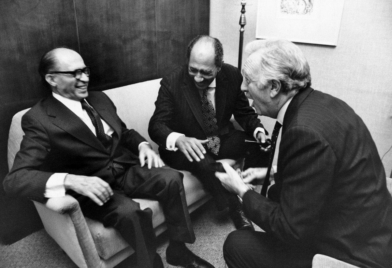 Israeli Prime Minister Menachem Begin and Egyptian President Anwar al-Sadat laugh with Cronkite at the King David Hotel in Jerusalem in November 1977.