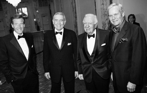 Cronkite poses in 2004 with newsmen Brian Williams, left, Dan Rather and Tom Brokaw.