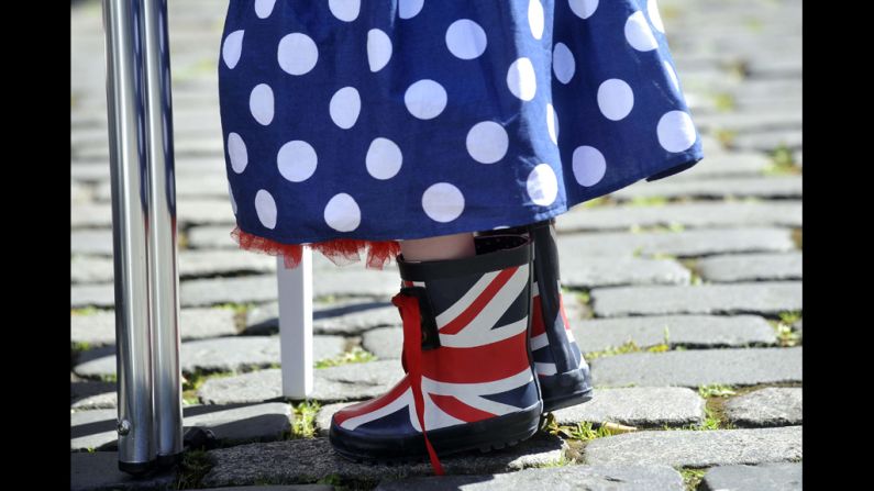 A small girl wears Union Jack boots and a skirt in Britain's colors during a street party.