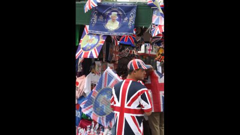 A vendor sells Union Jack and Diamond Jubilee memoribilia.