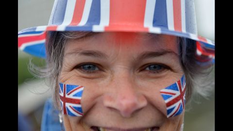 A woman watches the River Pageant from the Westminster Bridge.