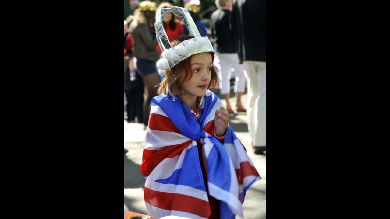 A young girl wearing a crown is wrapped in a Union flag during a street party to celebrate the Queen's Diamond Jubilee in Edinburgh.