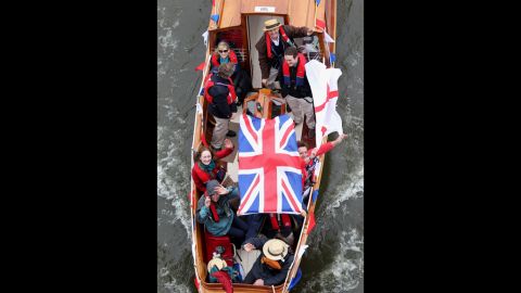 Revellers enjoy the River Pageant on the River Thames.