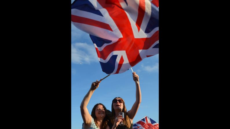 Spectators wave Britain's Union flag in London's Hyde Park as they watch the Diamond Jubilee Concert.
