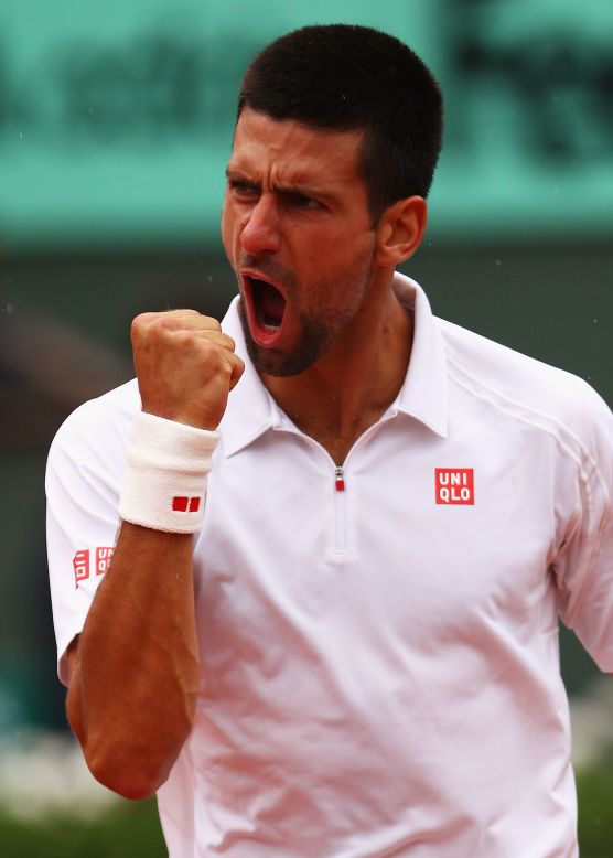 Novak Djokovic roars with relief after coming through his five-set quarterfinal against French Open crowd favorite Jo-Wilfried Tsonga at Roland Garros. 