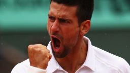 Novak Djokovic roars with relief after coming through his five-set quarterfinal against French Open crowd favorite Jo-Wilfried Tsonga at Roland Garros. 
