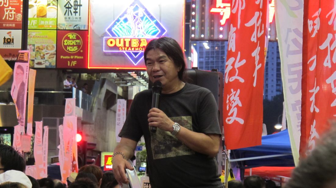 Democratic political activist and founding member of the League of Social Democrats, Leung Kwok-hung (popularly known as "Long Hair"), rouses the crowds heading to Victoria Park.