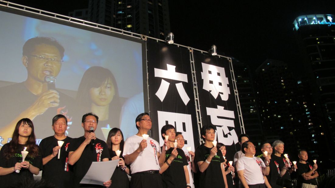 Representatives from the Hong Kong Alliance in Support of Patriotic Democratic Movements of China and Hong Kong Federation of Students take to the stage against a backdrop imploring "Don't forget June 4."
