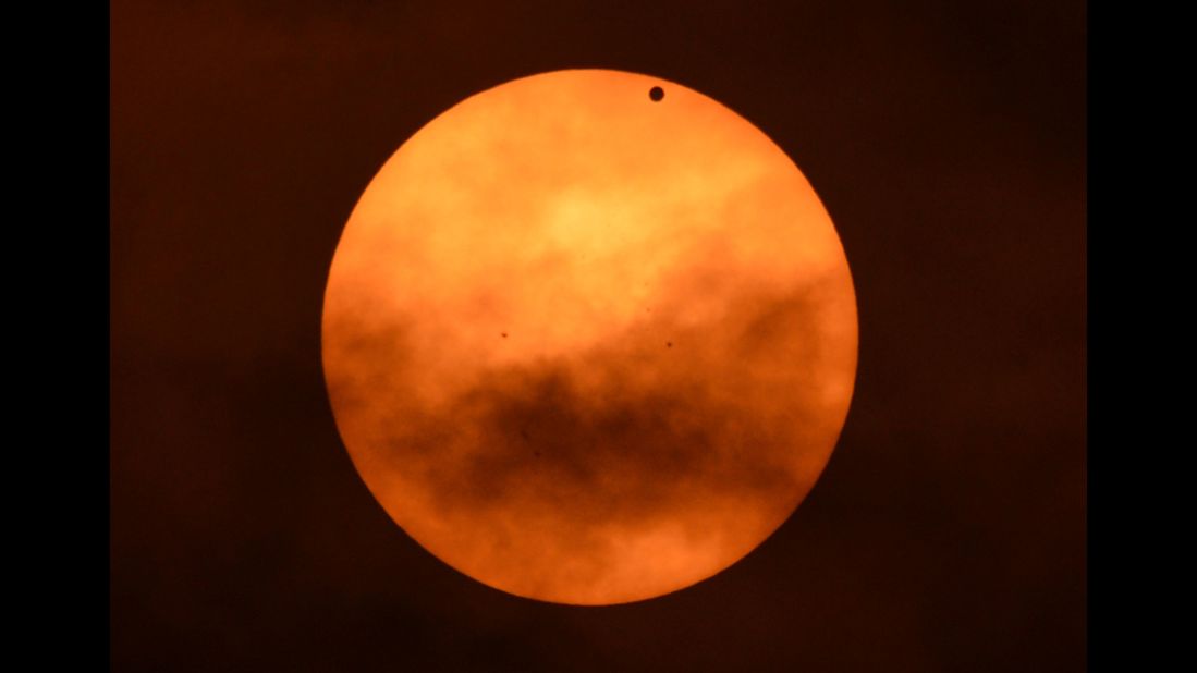 Venus appears as a black spot against the sun on Tuesday, as seen from the west side of Manhattan in New York. Astronomers around the world are training their telescopes on the skies to watch the transit of Venus as it passes between Earth and the sun.