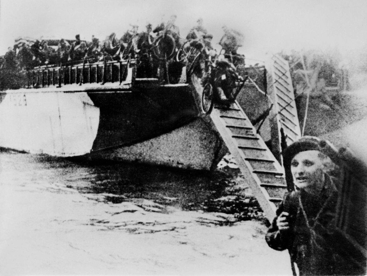 French commandos equipped with bicycles disembark from their landing craft after Allied forces stormed the Normandy beaches. Germans rained mortars and artillery down on Allied troops, killing many before they could even get out of their boats. Fighting was especially fierce at Omaha Beach, where Nazi fighters nearly wiped out the first wave of invading forces and left the survivors struggling for cover.