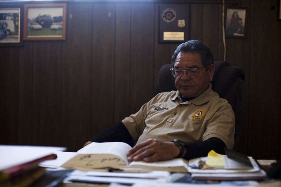 Luna County Sheriff Raymond Cobos at his desk in Deming, New Mexico. After Columbus was raided by federal agents and several officials were accused of arms trafficking, the village police department collapsed. The Luna County Sheriff's Department now polices the town and its surrounding area.  