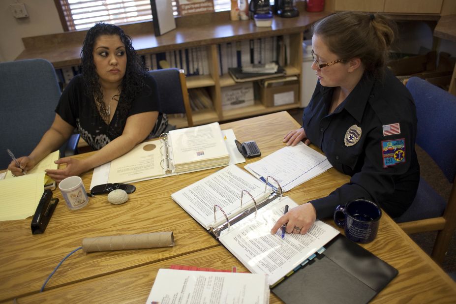 Columbus Mayor Nicole Lawson, right, goes over minutes with municipal clerk Natalia Baeza. Lawson, who became mayor last year, is trying to help the village overcome a huge budget shortfall after last year's federal raid.  