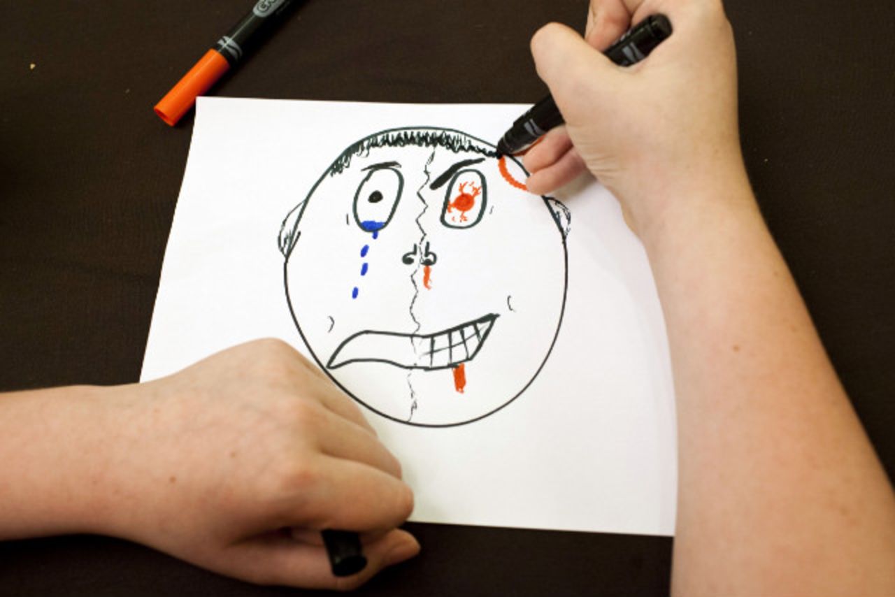 Shawn Semzock draws an image of sadness and anger to explain his grief.