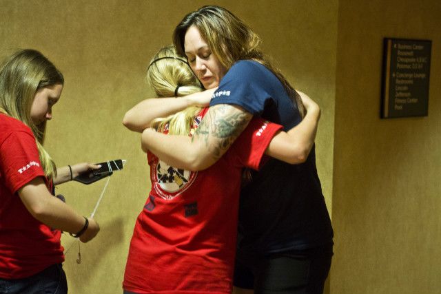 Hannah Tjaden hugs mentor Destini English at camp.