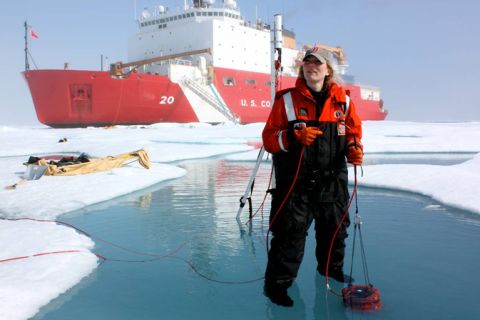 ICESCAPE scientist Karen Frey takes optical measurements in a melt pond, which lets four times as much light through to the sea below as snow-covered ice.
