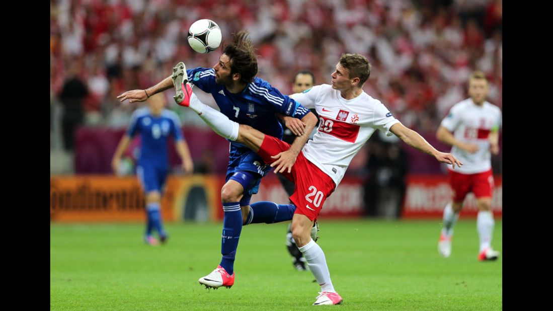 Lukasz Piszczek of Poland and Georgios Samaras of Greece battle for the ball during the opening match.